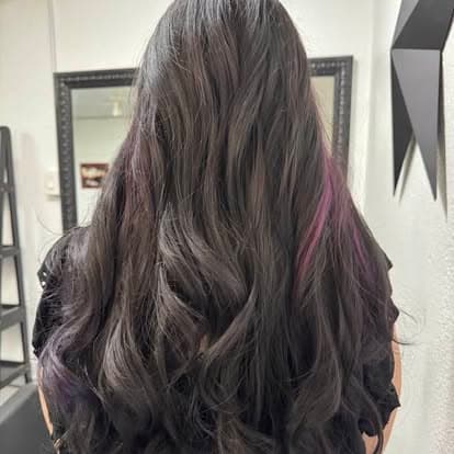 Dark waves with purple and magenta streaks, seen from behind